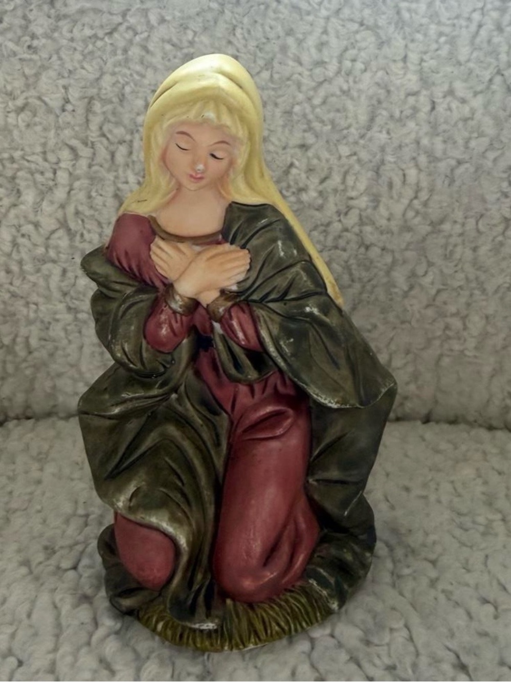 Mary statue with gold and red robes, kneeling with hands clasped. #religious #ch